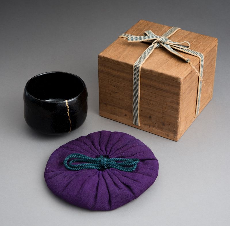 An Antique Black Raku Tea Bowl with Gold Repair