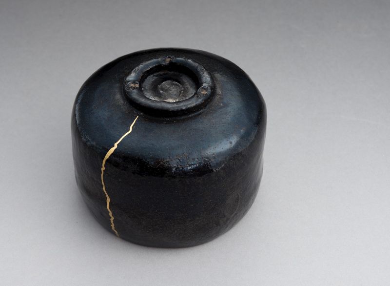 An Antique Black Raku Tea Bowl with Gold Repair
