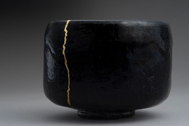 An Antique Black Raku Tea Bowl with Gold Repair