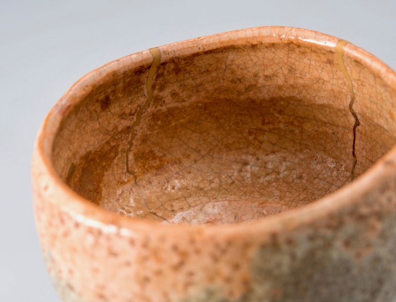 A Rare Tamamizu Red Raku Tea Bowl with Gold Repairs