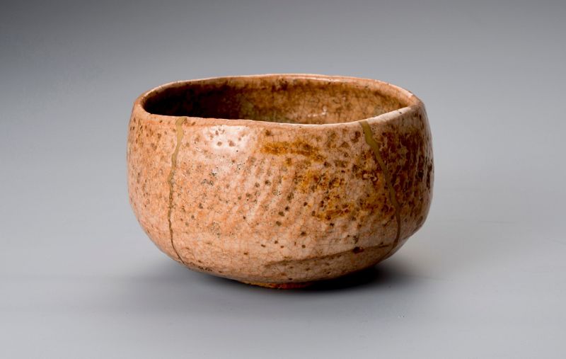 A Rare Tamamizu Red Raku Tea Bowl with Gold Repairs