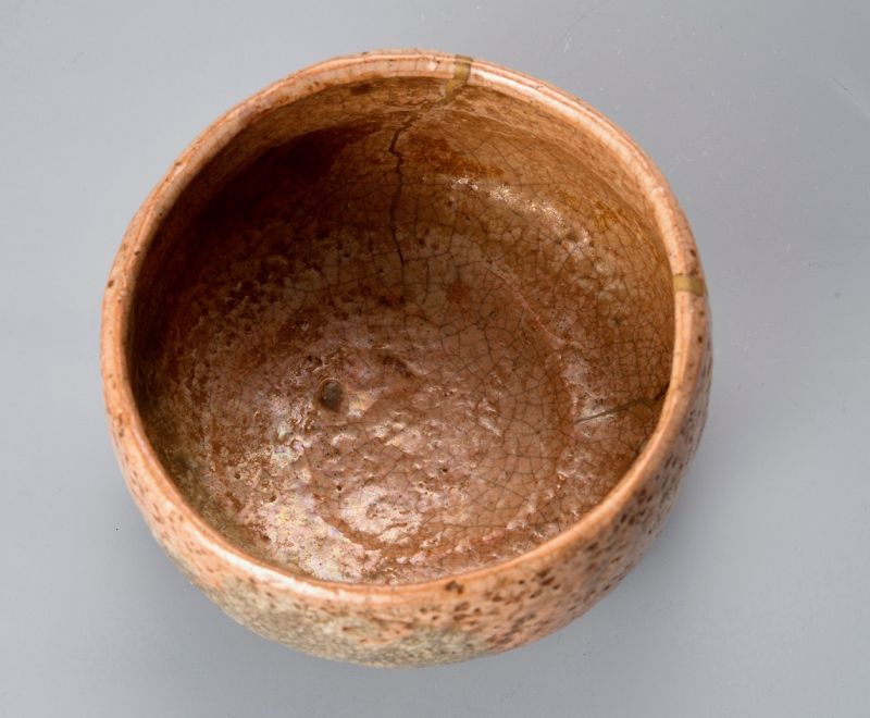 A Rare Tamamizu Red Raku Tea Bowl with Gold Repairs
