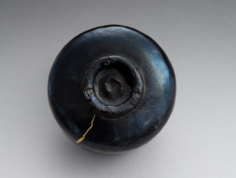 An Antique Black Raku Tea Bowl with Gold Repair