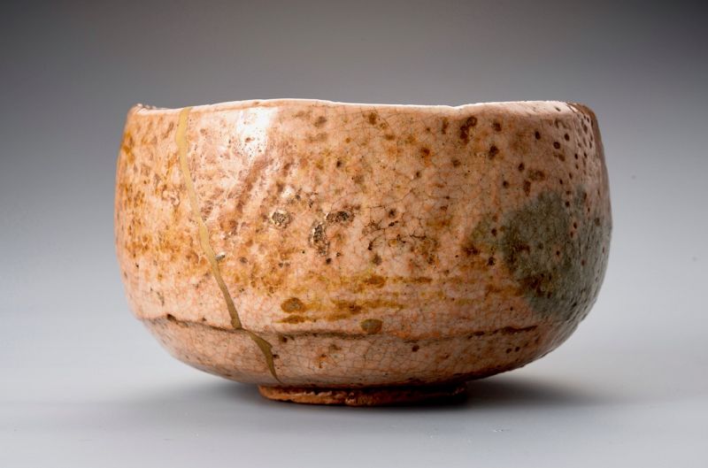 A Rare Tamamizu Red Raku Tea Bowl with Gold Repairs