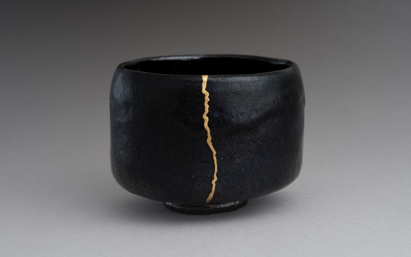 An Antique Black Raku Tea Bowl with Gold Repair