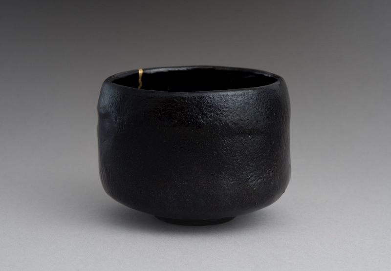 An Antique Black Raku Tea Bowl with Gold Repair